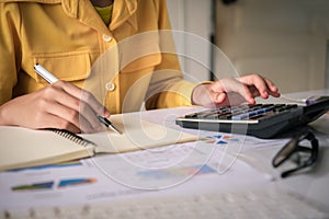 Businesswoman a working on accounts in business analysis with gr