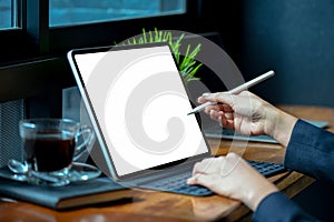 Businesswoman working on blank screen modern tablet in office