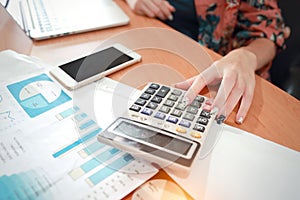 Businesswoman working with calculator and smart phone and computer