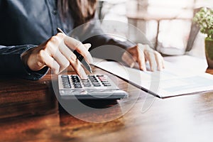 Businesswoman working on calculator to calculate business data the financial