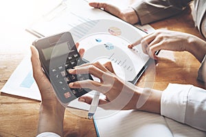 Businesswoman working on calculator to calculate business data t