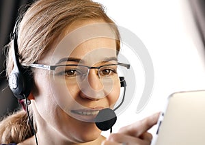 Businesswoman working in a call center. customer service proffessional talking on headset.