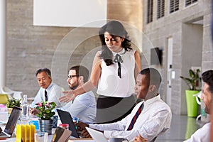 Businesswoman Working With Colleagues At Boardroom Table