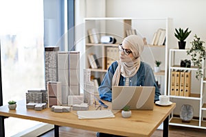 Businesswoman working on computer in architecture office