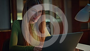 Businesswoman working computer evening apartment close up. Woman reading email