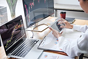 Businesswoman working with computer, laptop, thinking and analyzing graph stock market trading with stock chart data planning,