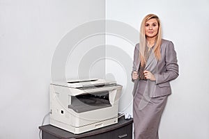 Businesswoman working on a copy machine at the office