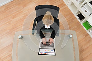 Businesswoman Working On Financial Data With Laptop