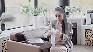 Businesswoman working from home woman paying bills. Image of a young pretty businesswoman working from home. Remote work