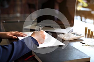 Businesswoman working with income statement document on the wood table.Business concept