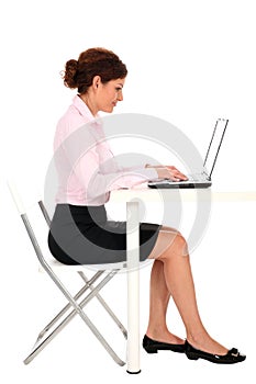 Businesswoman working on laptop photo