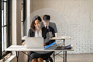 Businesswoman working with laptop computer in business office workplace