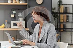 Businesswoman working on laptop during lunch