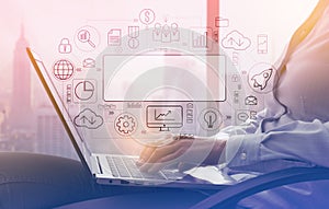 Businesswoman working with a laptop next to a window