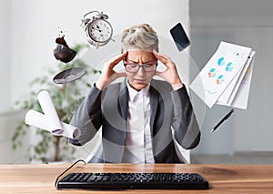 Businesswoman working on a laptop, overworking, under pressure