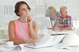 Businesswoman working in modern light office with her colleagues