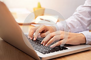 Businesswoman working with notebook laptop computer, using finger with keyboard for typing or keying