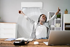 Businesswoman Working In Office With Air Conditioning