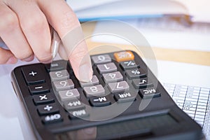 Businesswoman working in the office with calculator for financial data analyzing counting. Business financial analysis and