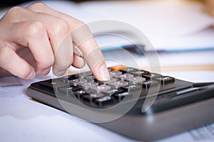 Businesswoman working in the office with calculator for financial data analyzing counting. Business financial analysis and