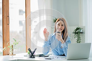Businesswoman working in the office during coffee break smiling at the window giving a clear vision of work and success instilling