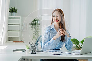 Businesswoman working in the office during coffee break smiling at the window giving a clear vision of work and success instilling