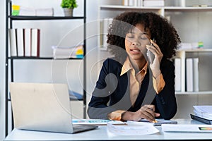 Businesswoman working in office connecting, contacting and chatting with customers. Professional woman plans table with smartphone