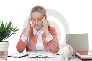 Businesswoman working at office desk is having an headache