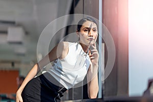 Businesswoman working in the office with looking out of the window