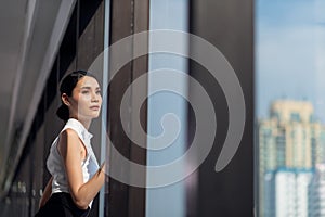 Businesswoman working in the office with looking out of the window