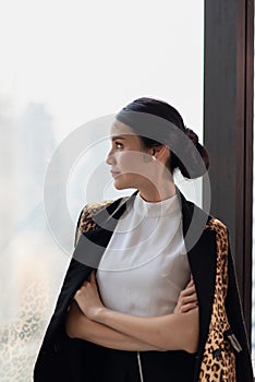 Businesswoman working in the office with looking out of the window