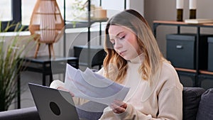 Businesswoman Working Online With Documents And Laptop At Home