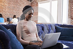 Businesswoman Working On Sofa In Modern Creative Office