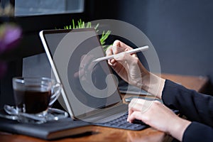 Businesswoman working with stylus and digital tablet pc at a coffee shop
