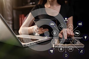 Businesswoman working with tablet and using a calculator to calculate the numbers of static in office.