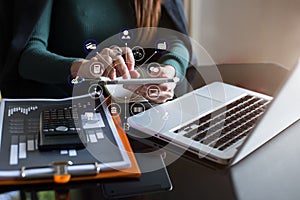 Businesswoman working with tablet and using a calculator to calculate the numbers of static in office. Finance accounting concept