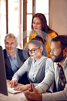 Businesswoman working with team on computer