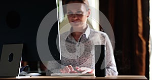 Businesswoman works on computer next to humidifier