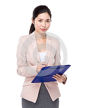 Businesswoman write on clipboard