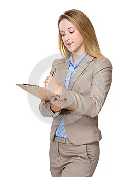 Businesswoman write on clipboard