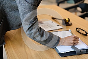 businesswoman write note while reviewing contract. woman conside