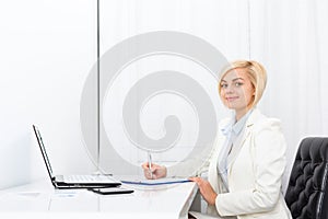 Businesswoman writing contract, signing document