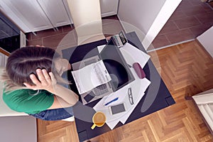 Businesswoman writing home budget with calculator top view