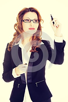 Businesswoman writing something on abstract screen