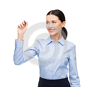 Businesswoman writing something in the air