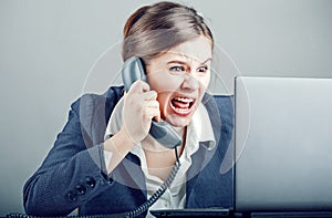 Businesswoman yelling into the phone