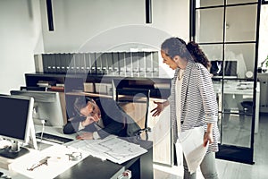 Businesswoman yelling at her employee sleeping at work