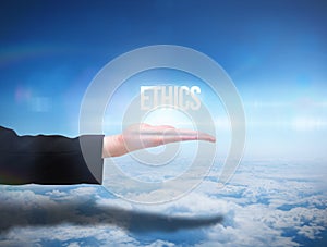 Businesswomans hand presenting the word ethics