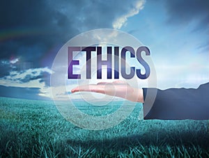 Businesswomans hand presenting the word ethics