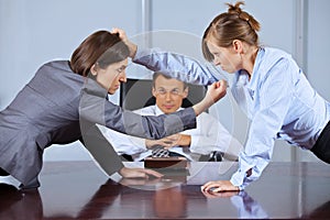 Businesswomen arguing in front of businessman at office